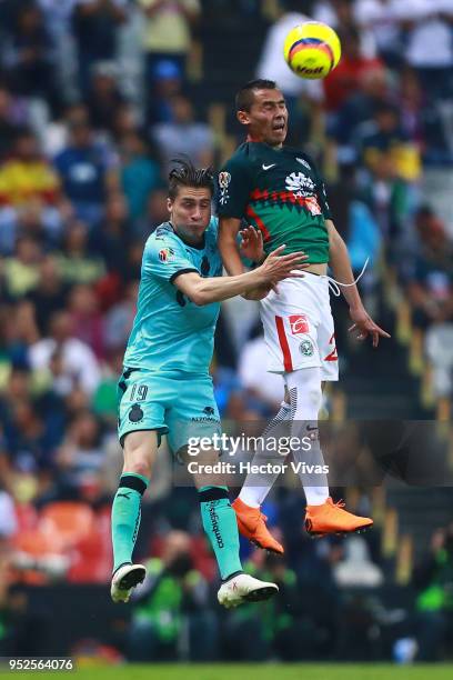 Jorge Flores of Santos Laguna struggles for the ball with Paul Aguilar of America during the 17th round match between America and Santos Laguna as...