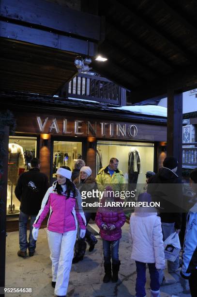 Family of russian tourists go to shopping at the Valentino luxury and fashion shop, Courchevel 1850 ski resort, Trois Vallees skiing area, Tarentaise...