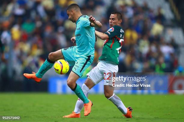 Gerardo Alcoba of Santos Laguna struggles for the ball with Paul Aguilar of America during the 17th round match between America and Santos Laguna as...