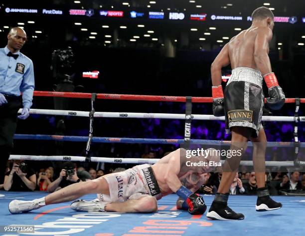 Daniel Jacobs of the USA knocks down Maciej Sulecki of Poland in the 12th round during their WBA World Middleweight Title bout at Barclays Center on...