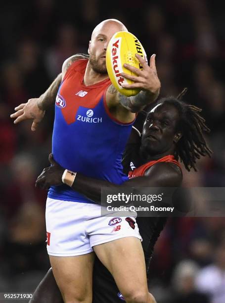 Nathan Jones of the Demons is tackled by Anthony McDonald-Tipungwuti of the Bombers during the round 6 AFL match between the Essendon Bombers and...