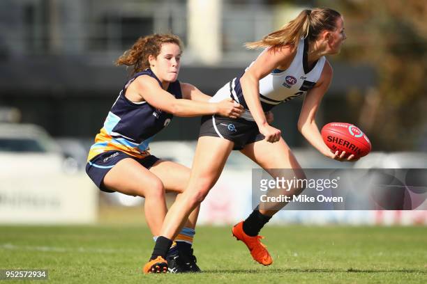 Gabrielle Newton of the Knights is tackled by Megan Williamson of the Pioneers during the round 7 TAC Cup match between the Northen Nights and...