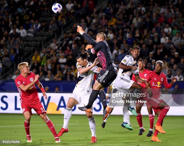 Luis Robles of New York Red Bulls clears the ball on a cross as he collides with Zlatan Ibrahimovic of Los Angeles Galaxy during the second half of a...