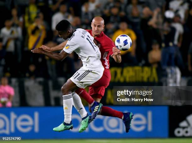 Aurelien Collin of New York Red Bulls clears the ball from Ola Kamara of Los Angeles Galaxy during the first half at StubHub Center on April 28, 2018...
