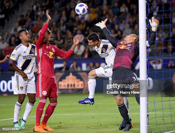 Daniel Steres of Los Angeles Galaxy collides with Luis Robles of New York Red Bulls as Michael Murillo and Ola Kamara look on during the second half...