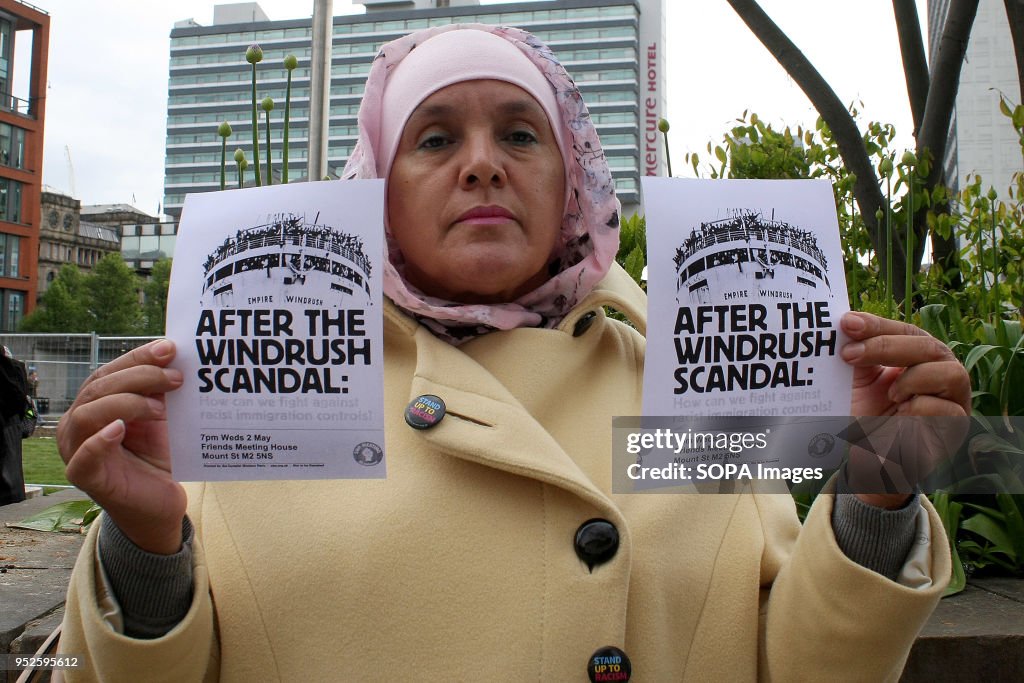 A woman holds two "After the Windrush Scandal" flyers during...