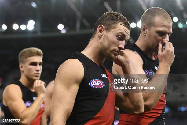 Devon Smith and Jake Stringer of the Bombers look dejected after losing the round 6 AFL match between the Essendon Bombers and Melbourne Demons at...