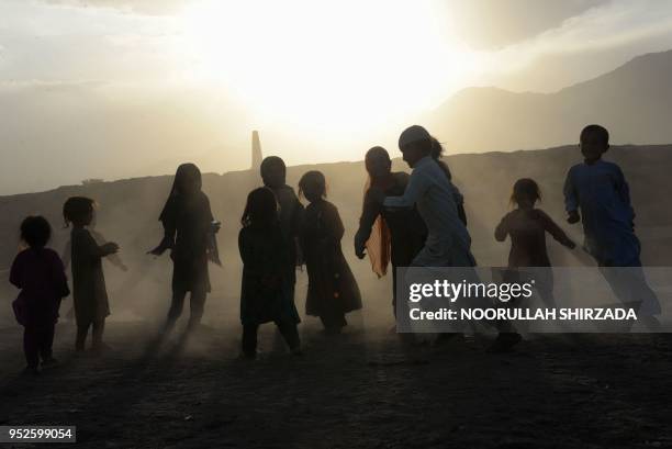 In this photograph taken on April 28 Afghan children play on the outskirts of Jalalabad.