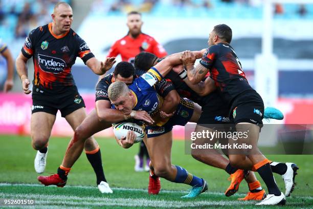 Daniel Alvaro of the Eels is tackled during the round Eight NRL match between the Parramatta Eels and the Wests Tigers at ANZ Stadium on April 29,...