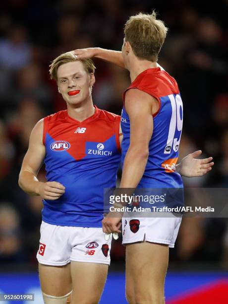 Debutant, Charlie Spargo of the Demons celebrates his first AFL goal with Mitch Hannan of the Demons during the 2018 AFL round six match between the...