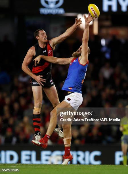 Matthew Leuenberger of the Bombers and Max Gawn of the Demons compete in a ruck contest during the 2018 AFL round six match between the Essendon...