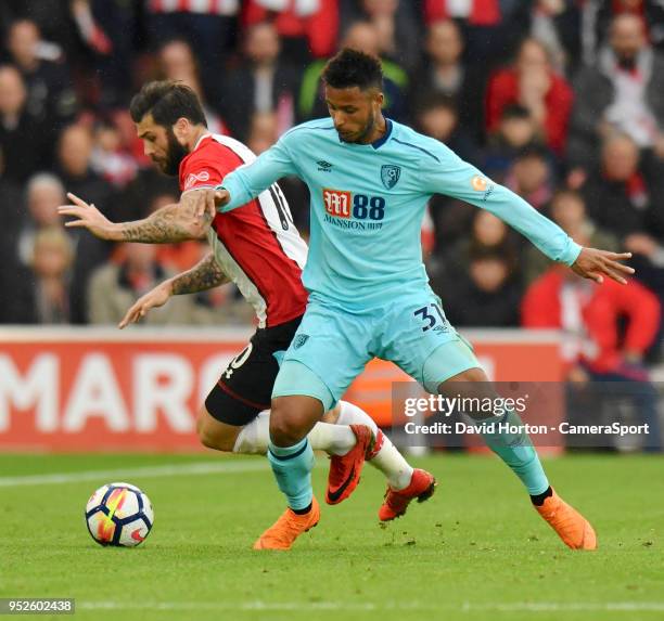 Bournemouth's Lys Mousset vies for possession with Southampton's Charlie Austin during the Premier League match between Southampton and AFC...