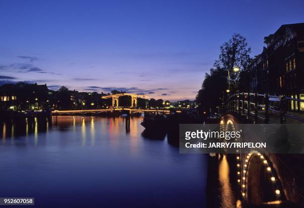 The Magere Brug bridge on the Amstel river by night, Amsterdam, Noord Holland region, Netherlands, Holland.