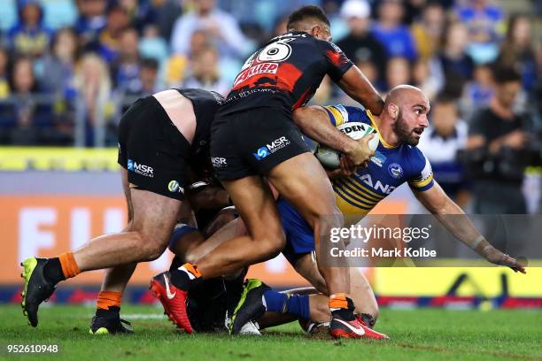 Tim Mannah of the Eels is tackled during the round Eight NRL match between the Parramatta Eels and the Wests Tigers at ANZ Stadium on April 29, 2018...