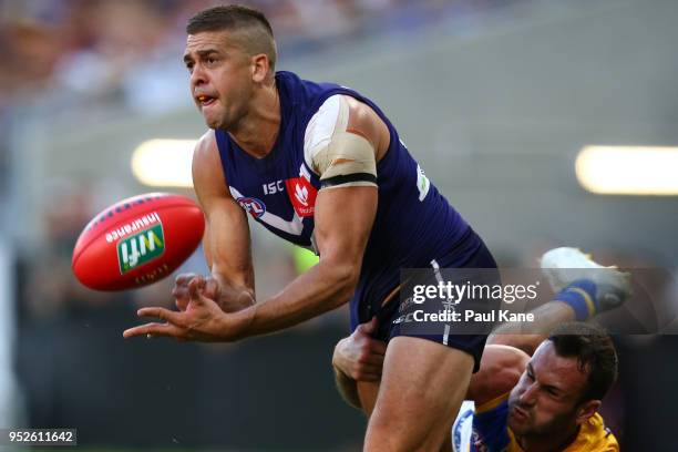 Stephen Hill of the Dockers handballs during the Round 6 AFL match between the Fremantle Dockers and West Coast Eagles at Optus Stadium on April 29,...