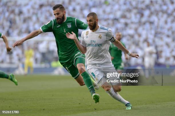 Karim Benzema of Real Madrid fight the ball with Siovas of Leganes during a match between Real Madrid vs Leganes for La Liga Española at Santiago...