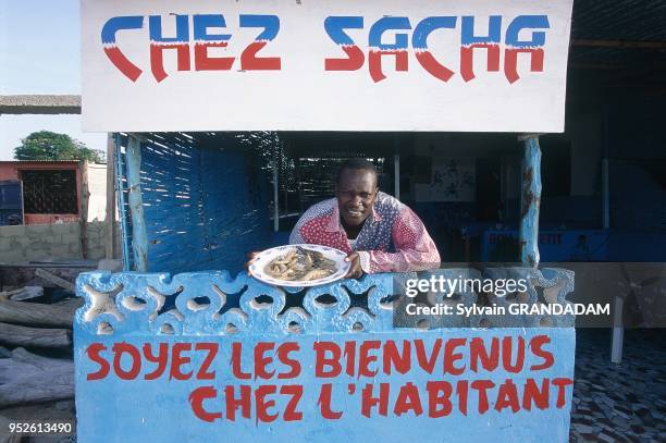 SENEGAL.PETITE COTE.SALY.MR SACHA DIALLO FISHERMAN HAS OPEN A SMALL RESTAURANT FOR TOURISTS ON THE BEACH.SHOWING FRESHLY CAUGHT PRAWNS.