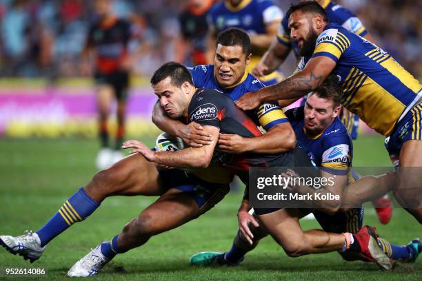 Corey Thompson of the Tigers is tackled during the round Eight NRL match between the Parramatta Eels and the Wests Tigers at ANZ Stadium on April 29,...