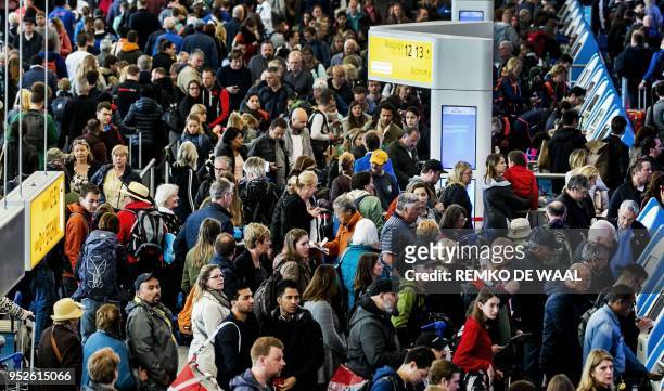 Passengers gather in the Departure hall of Schiphol Airport in Amsterdam on April 29 after some flights were cancelled or delayed because of a major...