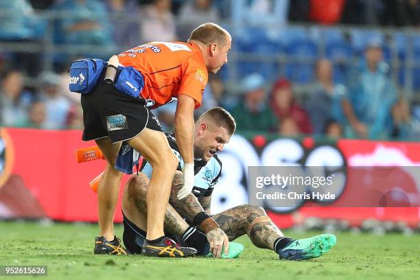 Josh Dugan of the Sharks leaves the field injured during the round eight NRL match between the Gold Coast Titans and Cronulla Sharks at Cbus Super...