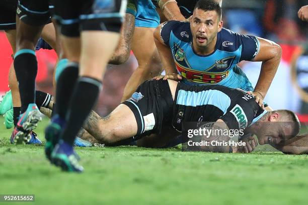 Josh Dugan of the Sharks leaves the field injured during the round eight NRL match between the Gold Coast Titans and Cronulla Sharks at Cbus Super...