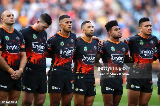 The Tigers sing the national anthem during the ANZAC ceremony before the round Eight NRL match between the Parramatta Eels and the Wests Tigers at...