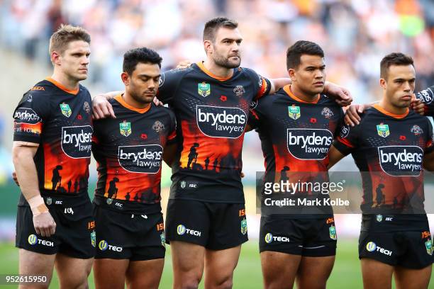 The Tigers sing the national anthem during the ANZAC ceremony before the round Eight NRL match between the Parramatta Eels and the Wests Tigers at...