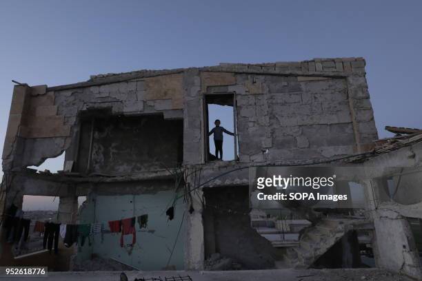 Girl displaced from Efrin stand outside her new home in the village of Ahras. An estimated 400,000 refugees fleeing the two-month-old Turkish...