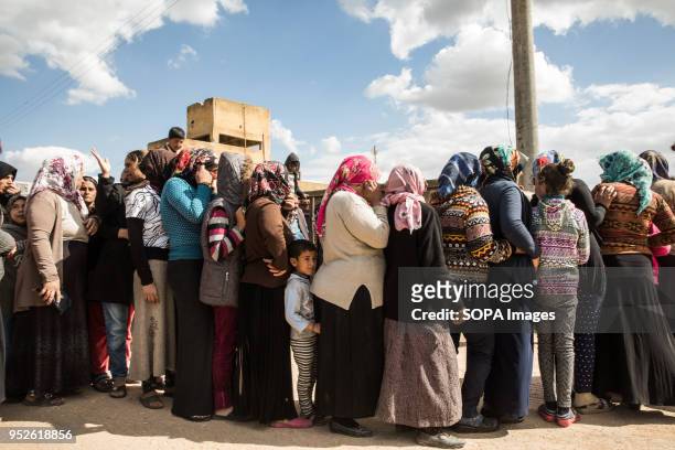 Refugees displaced from Efrin line up to receive bread from the Syrian Red Crescent in Ahras. An estimated 400,000 refugees fleeing the two-month-old...