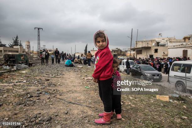 Hundreds of children reach out to aid workers distributing blankets, outside of Tall Rifat. An estimated 400,000 refugees fleeing the two-month-old...