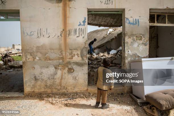 Children play in the rubble of an empty home they resettled after being displaced from the conflict in Afrin. An estimated 400,000 refugees fleeing...