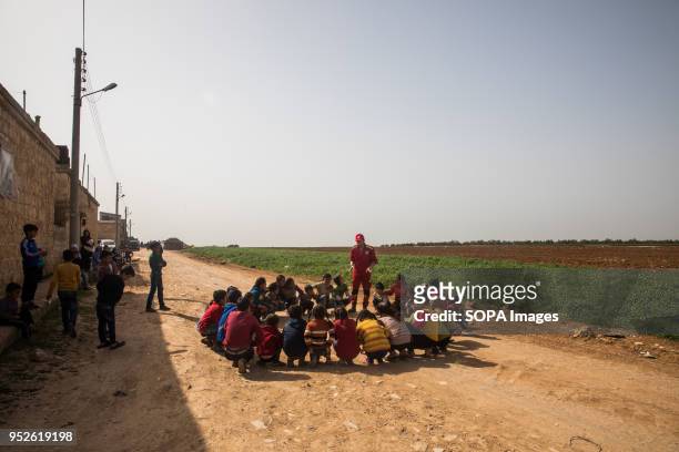 Children displaced from Efrin play in the field with the Syrian Red Crescent volunteers in Ahras. An estimated 400,000 refugees fleeing the...