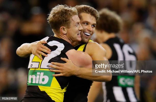 Josh Caddy and Dan Butler of the Tigers celebrate during the 2018 AFL round six match between the Collingwood Magpies and the Richmond Tigers at the...