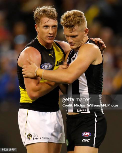 Josh Caddy of the Tigers and Adam Treloar of the Magpies shake hands after the 2018 AFL round six match between the Collingwood Magpies and the...