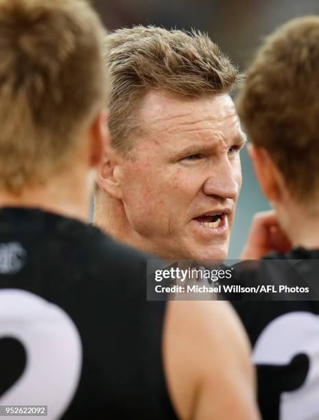 Nathan Buckley, Senior Coach of the Magpies addresses his players during the 2018 AFL round six match between the Collingwood Magpies and the...