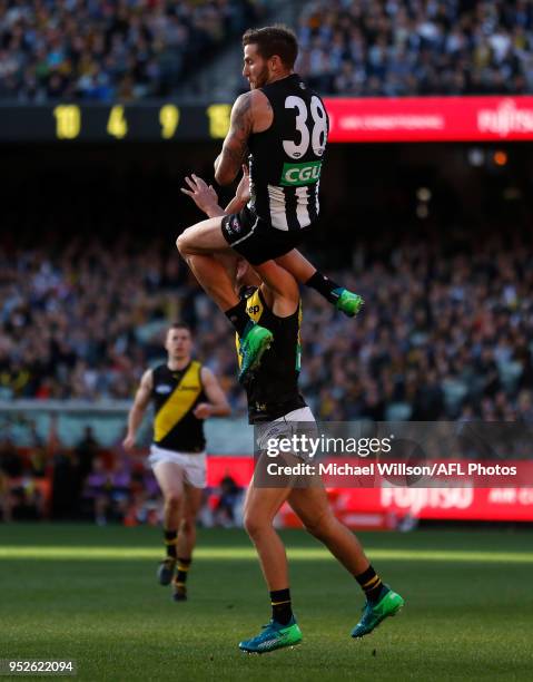 Jeremy Howe of the Magpies takes spectacular mark over Jason Castagna of the Tigers during the 2018 AFL round six match between the Collingwood...