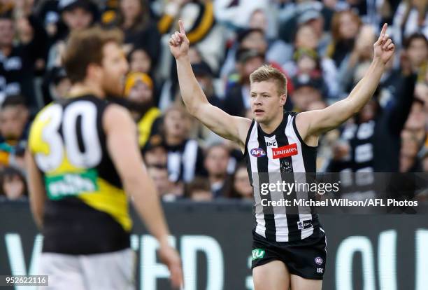 Jordan De Goey of the Magpies celebrates a goal during the 2018 AFL round six match between the Collingwood Magpies and the Richmond Tigers at the...