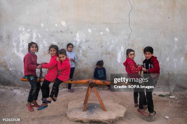 Syrian children playing in a park in Ahras in the northern Syrian enclave of Afrin. Tens of thousands of people were displaced by the Turkish-led...