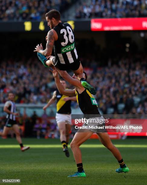 Jeremy Howe of the Magpies takes spectacular mark over Jason Castagna of the Tigers during the 2018 AFL round six match between the Collingwood...