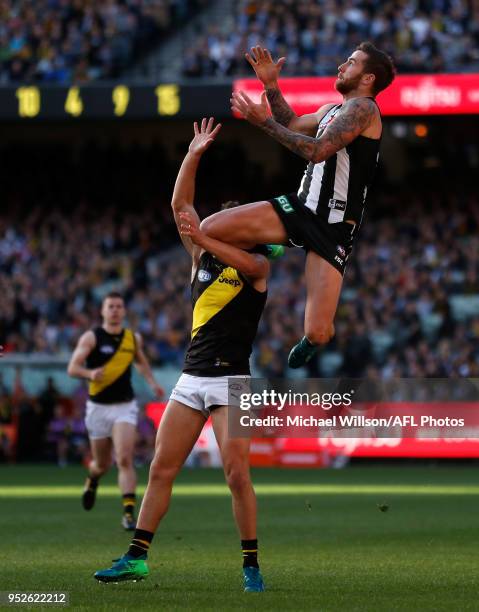 Jeremy Howe of the Magpies takes spectacular mark over Jason Castagna of the Tigers during the 2018 AFL round six match between the Collingwood...