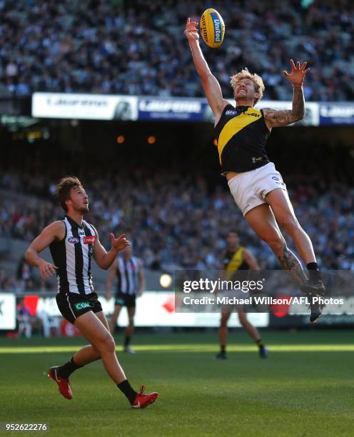 Nathan Broad of the Tigers and Tom Phillips of the Magpies compete for the ball during the 2018 AFL round six match between the Collingwood Magpies...