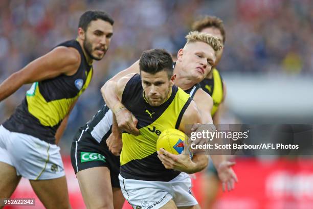 Trent Cotchin of the Tigers is tackled during the AFL round six match between the Collingwood Magpies and Richmond Tigers at Melbourne Cricket Ground...