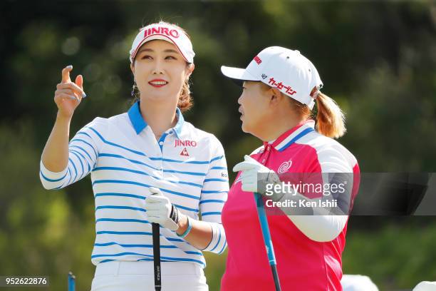 Ha-Neul Kim and Sun-Ju Ahn of Korea talk on the first hole during the final round of the CyberAgent Ladies Golf Tournament at Grand fields Country...