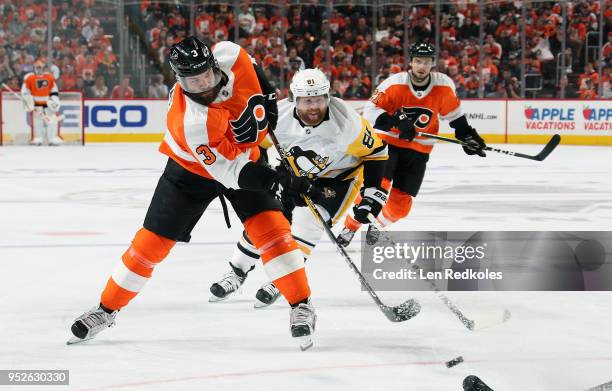 Radko Gudas of the Philadelphia Flyers shoots the puck against Phil Kessel of the Pittsburgh Penguins in Game Six of the Eastern Conference First...