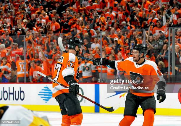 Andrew MacDonald of the Philadelphia Flyers celebrates his first period goal against the Pittsburgh Penguins with Ivan Provorov in Game Six of the...