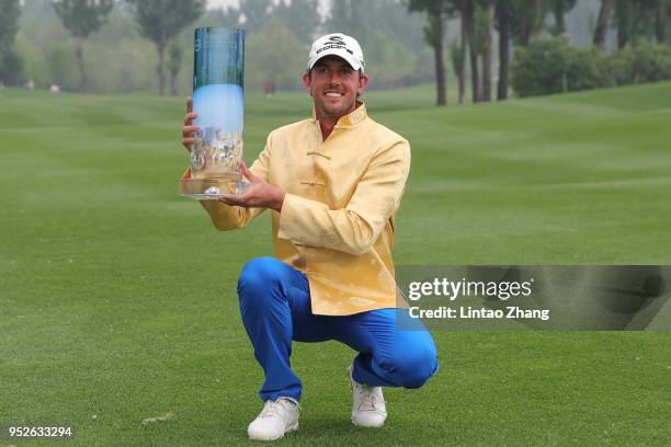 Alexander Bjork of Sweden holds the trophy celebrates after winning the 2018 Volvo China Open at Topwin Golf and Country Club on April 29, 2018 in...