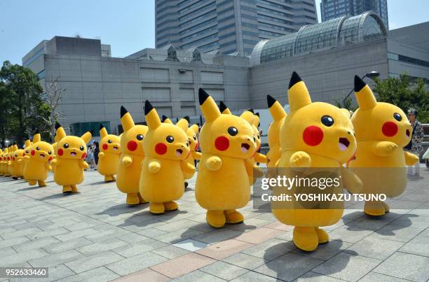 Pikachu characters, Nintendo's videogame software Pokemon's wellknown character, march at a shopping mall in Yokohama, suburban Tokyo on August 10,...