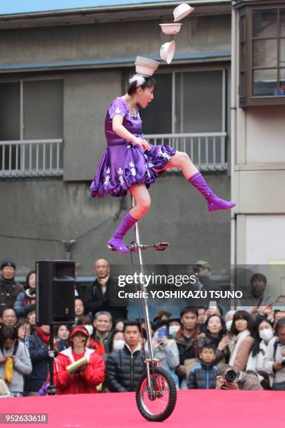 Chinese performer on a unicycle performs to celebrate Chinese Lunar New Year at Yokohama Chinatown in Yokohama, suburban Tokyo on January 29, 2017....