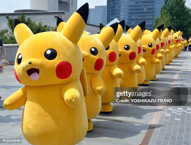 Pikachu characters, Nintendo's videogame software Pokemon's wellknown character, march at a shopping mall in Yokohama, suburban Tokyo on August 10,...