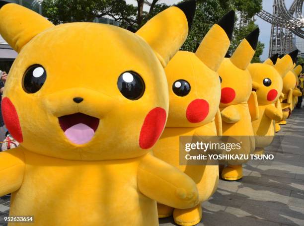 Pikachu characters, Nintendo's videogame software Pokemon's wellknown character, march at a shopping mall in Yokohama, suburban Tokyo on August 10,...